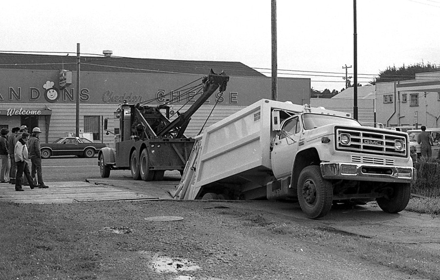 Garbage truck fell through platform, late 70s