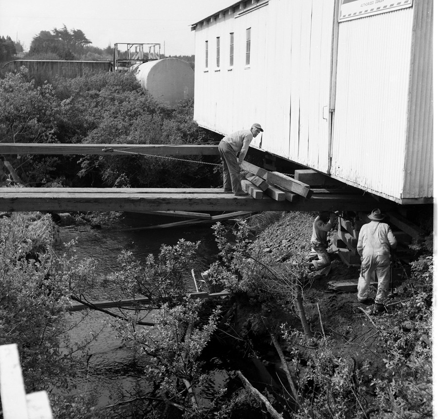 Feed store falling into Ferry Creek, 1956