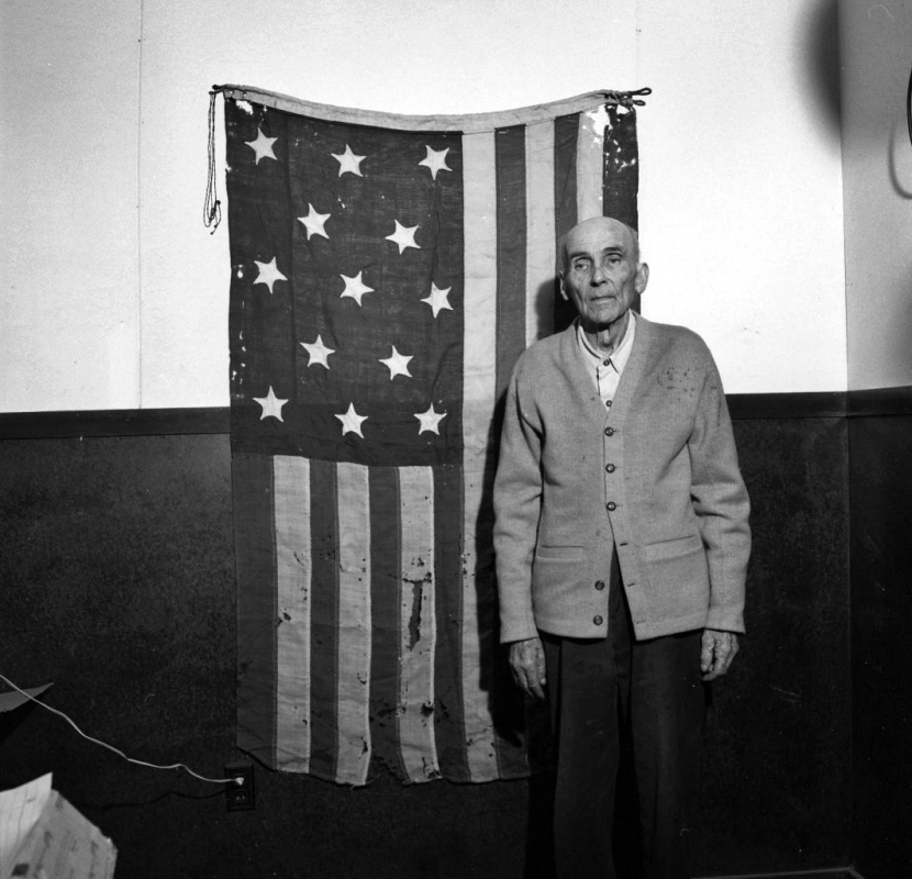 James Morrison w/historic flag, 1956